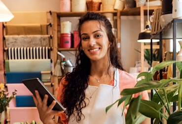 Flower shop owner holding a plant